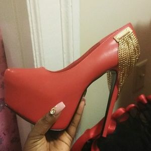 Red pumps with gold chains